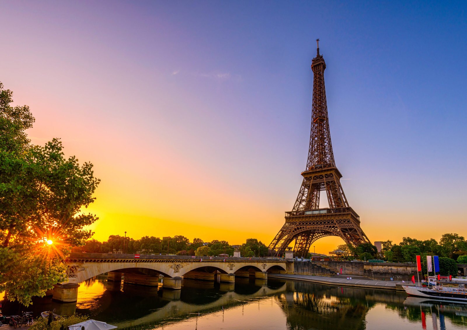 view of eiffel tower and river seine at sunrise in paris, france